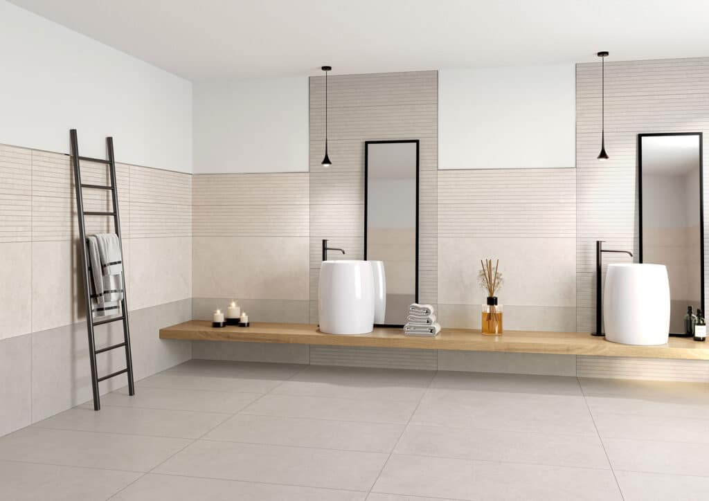 Salle de bain moderne épurée avec double vasque, comptoir en bois flottant, carrelage mural texturé, échelle porte-serviettes noire et suspensions minimalistes.